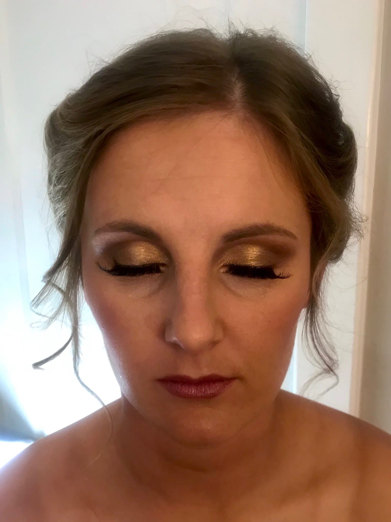 Bridal makeup with gold eyeshadow and berry lip